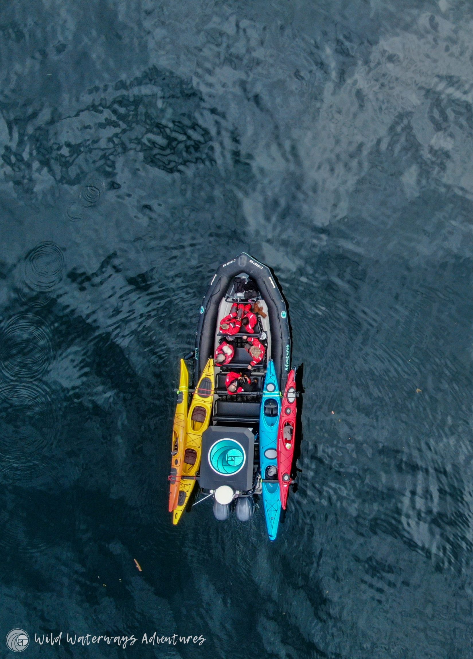 kayaks loaded on boat with guests